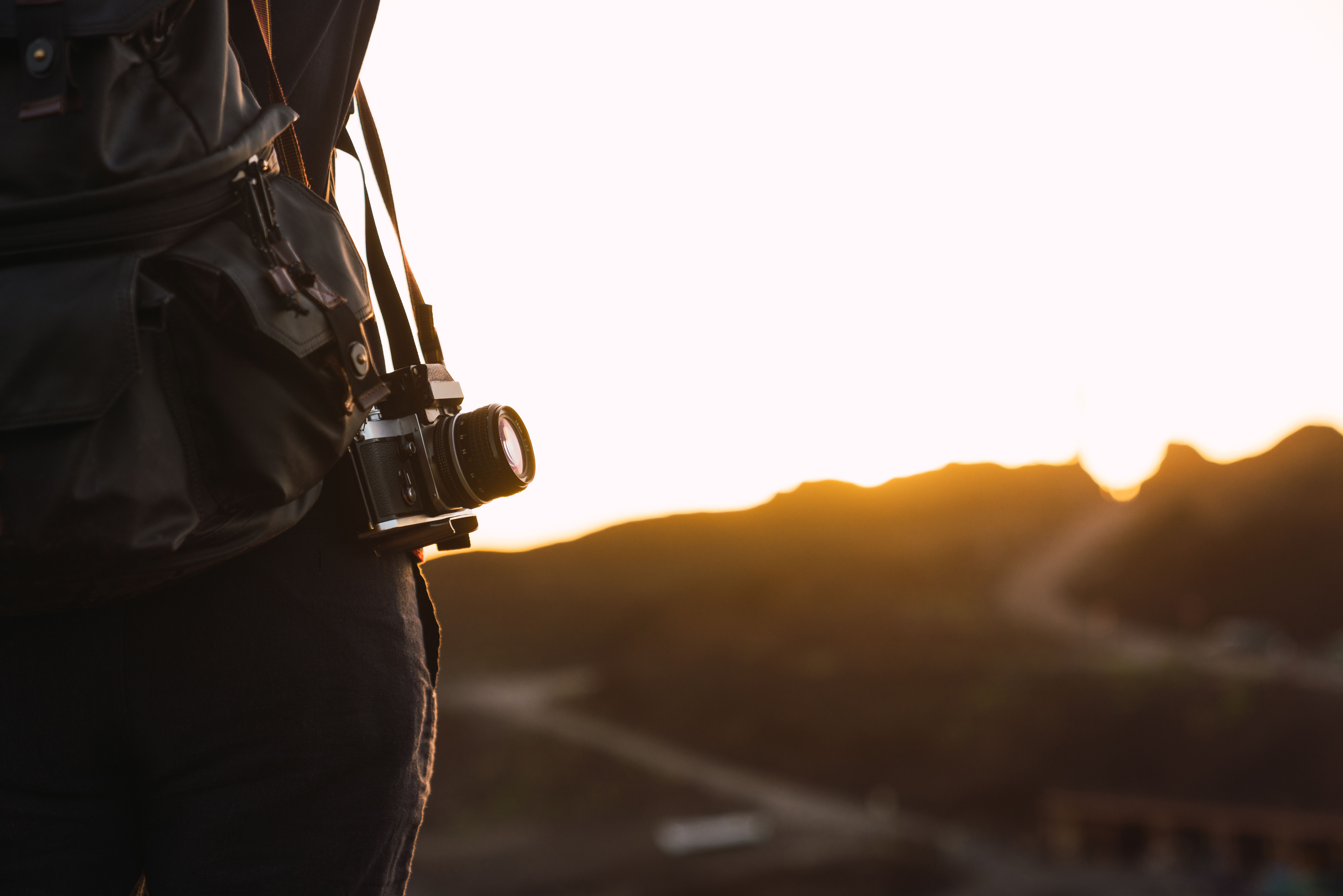 person-with-vintage-camera-and-backpack-on-mountai-2025-04-04-22-18-40-utc.jpg